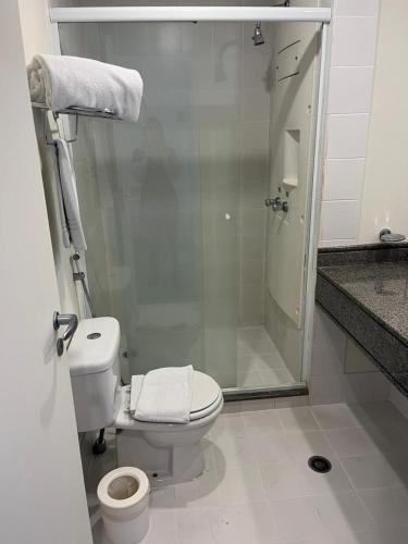 a bathroom with a toilet and a glass shower at Flat maravilhoso em frente aeroporto de Congonhas Nobile in Sao Paulo