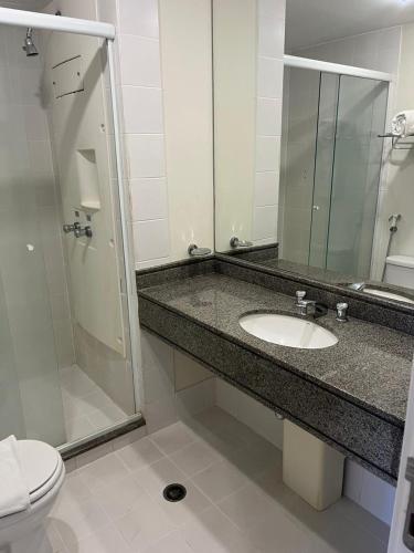 y baño con lavabo, ducha y aseo. en Flat maravilhoso em frente aeroporto de Congonhas Nobile, en São Paulo