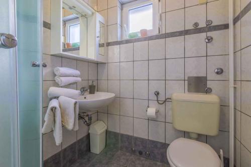 a bathroom with a toilet and a sink at One-Bedroom Apartment in Crikvenica XVI in Dramalj