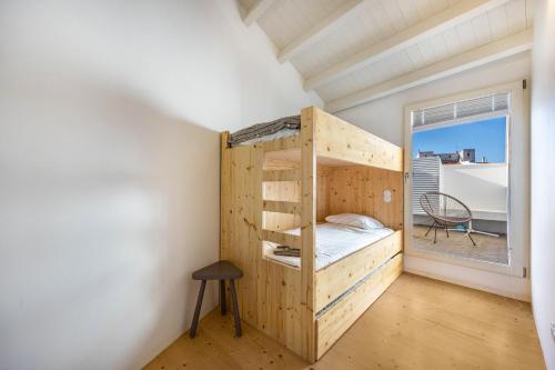 a bedroom with a bunk bed and a window at Olinda House in Odeceixe