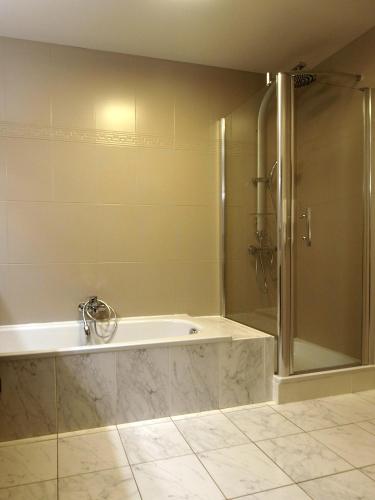 a bathroom with a shower and a bath tub at Private House in Blankenberge