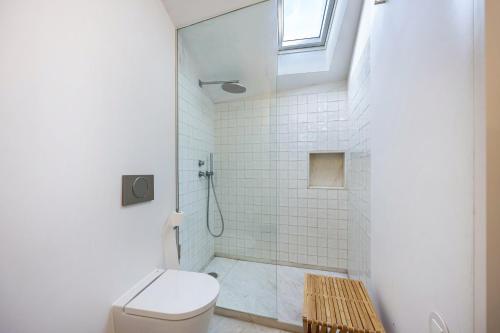a bathroom with a toilet and a shower at Olinda House in Odeceixe