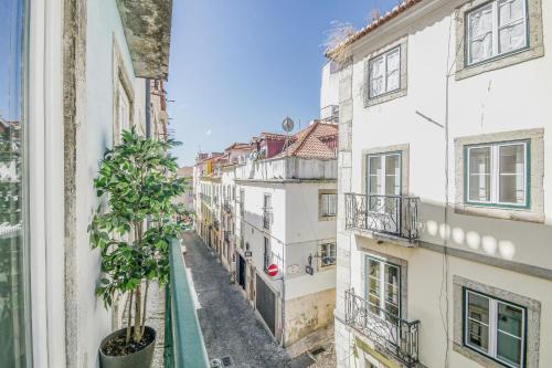 a view from a window of an alley between buildings at Bairro House Lisbon Charming Suites in Lisbon