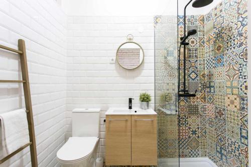 a bathroom with a toilet and a sink and a shower at St Amaro- Chic Terrace Studio Lisbon Congress in Lisbon