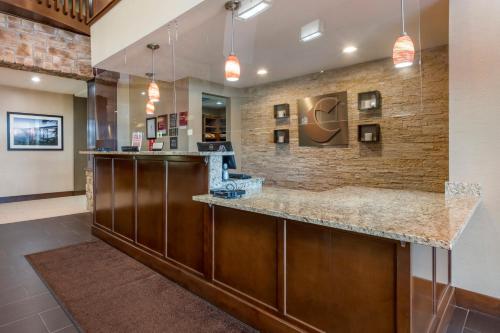 a lobby with a large counter with a bar at Comfort Suites Bridgeport - Clarksburg in Bridgeport