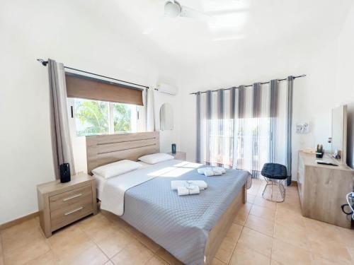 A bed or beds in a room at FAME villa with Private Pool and Gazebo