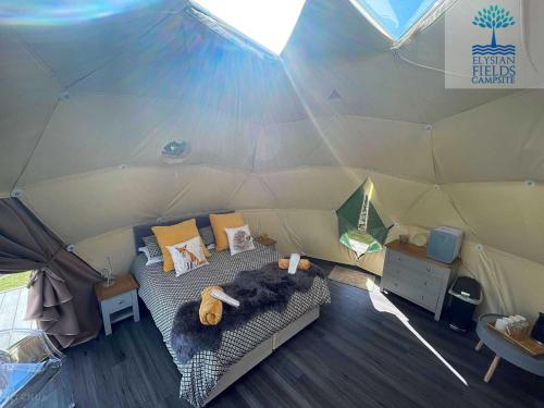a room with a bed in a tent at Glamping Dome Elysian Fields in Helston