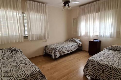 a room with two twin beds and a window at Casa quinta en la ruta 1 km 3.5 in Santa Fe