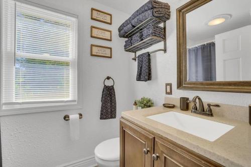 a bathroom with a sink and a mirror and a toilet at Lovely Bright Lansing Home 3 Bedrooms / 2 Bathrooms in Lansing