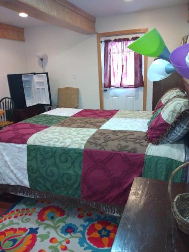 a hotel room with two beds with colorful sheets at No View Farm in Rumford