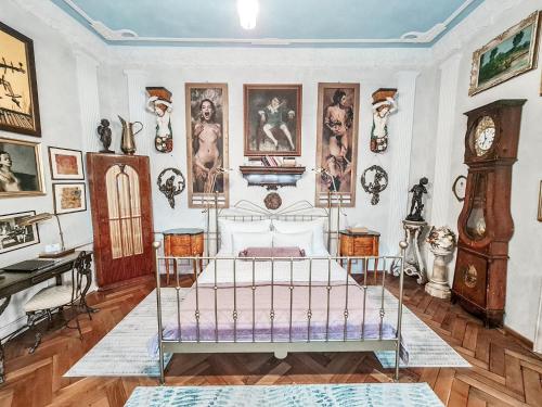 een kamer met een bed en veel foto's aan de muur bij Divná pani Luxury Gallery Rooms in Banská Štiavnica