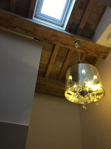a chandelier hanging from a ceiling with a window at The Cherry House, Apartamento Monterosa in Petritoli