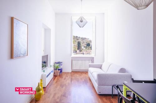 a living room with a white couch and a window at Belvedere Hambury Apartment by Wonderful Italy in Bordighera