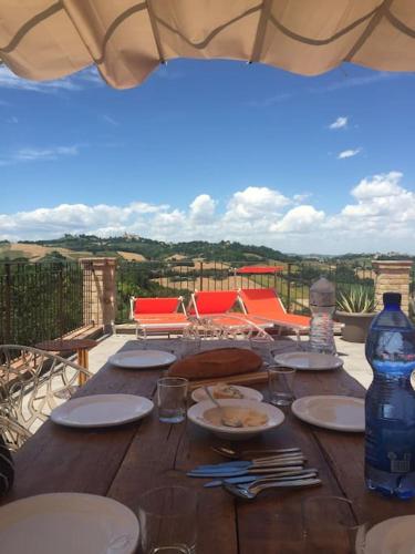 a wooden table with plates of food on top at The Cherry House, Apartamento Monterosa in Petritoli
