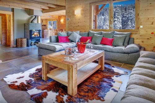 a living room with a couch and a table at Chalet Alex - OVO Network in Saint-Jean-de-Sixt