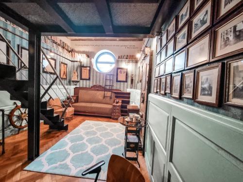 a living room with a couch and pictures on the walls at Divná pani Luxury Gallery Rooms in Banská Štiavnica