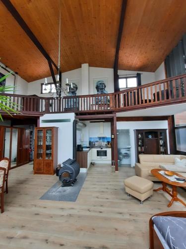 a living room with a staircase and a couch and a table at Ferienwohnung Altes Künstleratelier Weimar in Weimar