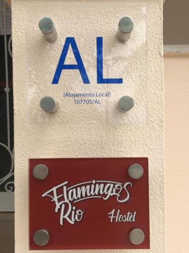 a sign for an al hamburgers riboked on a building at flamingos rio in Montijo