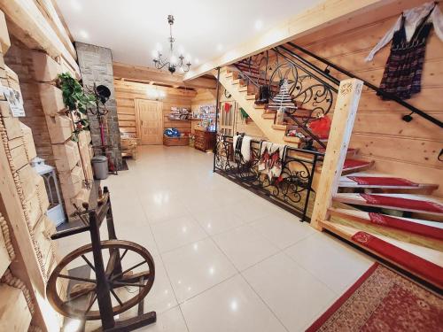 a large room with a staircase and wooden walls at Domek, Apartamenty i pokoje Willa Elita in Kościelisko