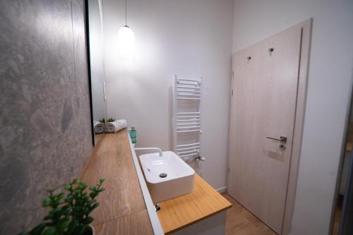 y baño con lavabo blanco y espejo. en Coente Apartments Király 28, en Budapest