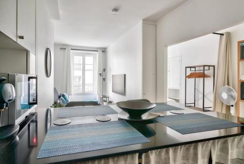 a living room with a table with a bowl on it at Nice apartment at 10 min from Bastille in Paris