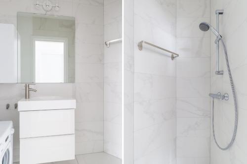 a white bathroom with a shower and a sink at K50171 Modern apartment near the center and free parking in Eindhoven