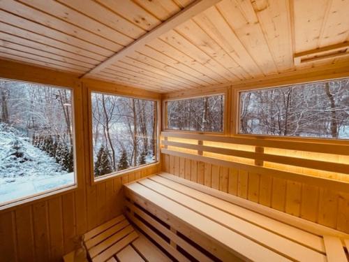 a wooden porch in a log cabin with windows at Dom Blisko Natury Boszkowo Letnisko Dom A in Boszkowo-Letnisko