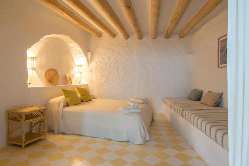 a bedroom with two beds in a white room at El Porró in Cadaqués