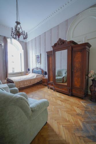 a large room with a bed and a couch at Leon Rooms in Tbilisi City