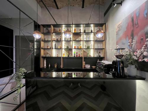 a bar with a shelf with bottles of alcohol at Capital Hotel Garni in Belgrade