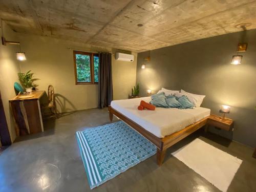 a bedroom with a bed and a blue rug at Sampaguita Villas in El Nido