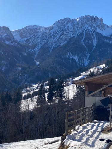 a snow covered mountain in front of a ski lodge at Sci Trekking Bike al Plan de Corones Kronplatz Dolomiti in Sorafurcia