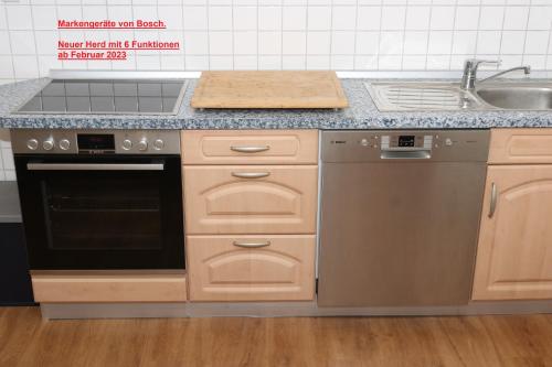 a kitchen with a stove and a sink at Landhaus Schlossblick in Sangerhausen