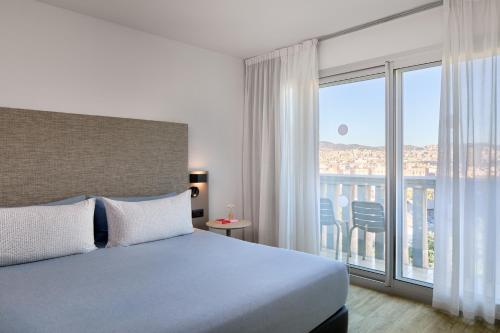 a hotel room with a bed and a balcony at INNSiDE by Meliá Barcelona Apolo in Barcelona