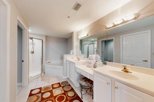 a white bathroom with two sinks and a mirror at Spanish Key 408 in Pensacola