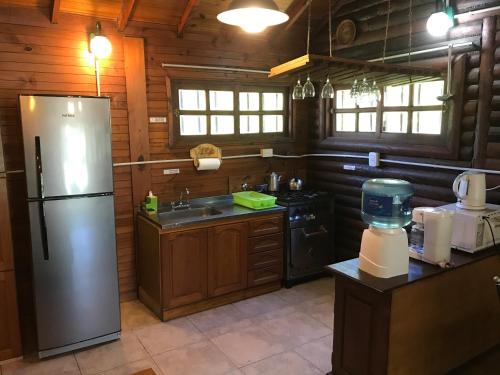 a kitchen with a stainless steel refrigerator in a cabin at Rio Manso Tigre in Tigre