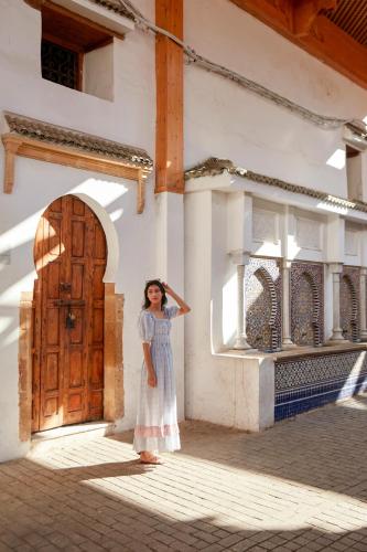 a woman standing in front of a building with a door at Fairmont La Marina Rabat Sale Hotel in Rabat