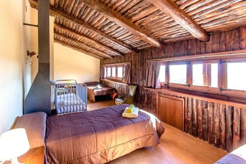 a bedroom with a bed in a room with wooden walls at Catalunya Casas Nature and Tranquility for 24 pax - 30km to beach in Sant Pere de Vilamajor