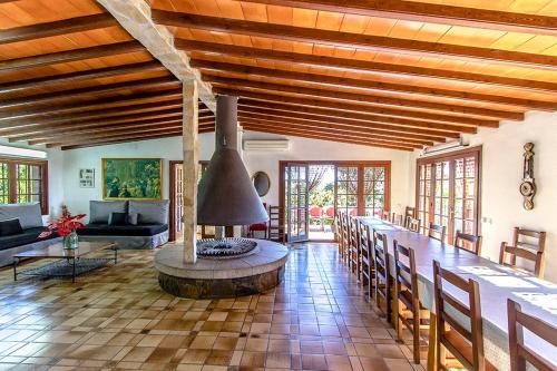 a living room with a table and a fireplace at Catalunya Casas Nature and Tranquility for 24 pax - 30km to beach in Sant Pere de Vilamajor