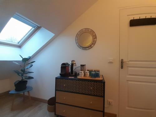 a room with a dresser and a mirror on the wall at Chez Marie et Hugo in Crépy-en-Valois