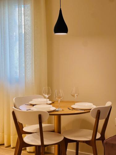 a dining room with a wooden table and chairs at Tirana Center Hideaway in Tirana