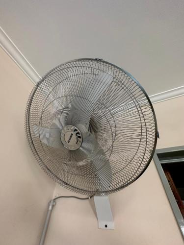 a metal fan is hanging from a ceiling at Apart Hotel Bari in Cordoba