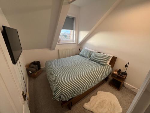 a small bedroom with a bed and a window at 1 or 2 bed in Folkestones West End in Folkestone