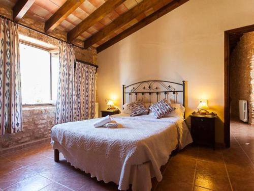 a bedroom with a large bed and a window at Son Fumat in Es Llombards