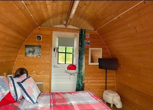 a bedroom with a bed and a sink in a cabin at Lovely Glamping Dream Pod in St Austell Cornwall in St Austell