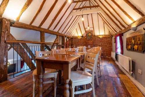 a dining room with a wooden table and chairs at The Evenhill in Canterbury