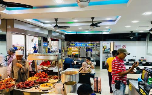 a group of people preparing food in a restaurant at City Central Hotel in Kuala Lumpur