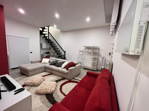 a living room with a red couch and a red rug at Il Canneto in Lomnago