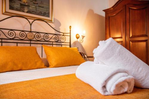 a bedroom with a bed with a towel on it at S’ammentu house in Bosa