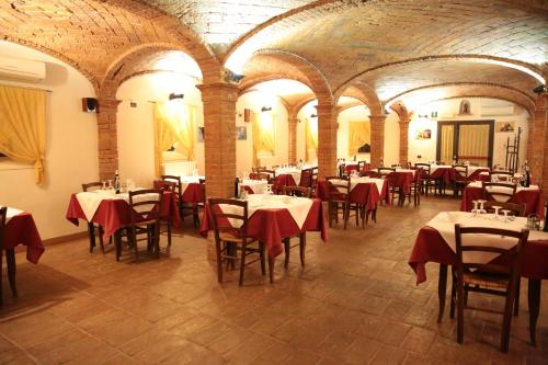 a dining room with tables and chairs in a building at Albergo Da Ca' Vecia in Spilamberto